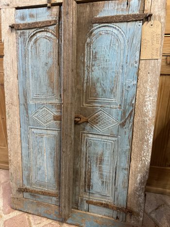 Wooden window frame and shutters.
